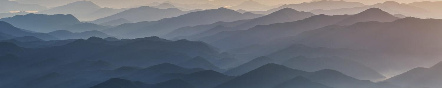 Header image of misty mountains, communicating layers of complexity